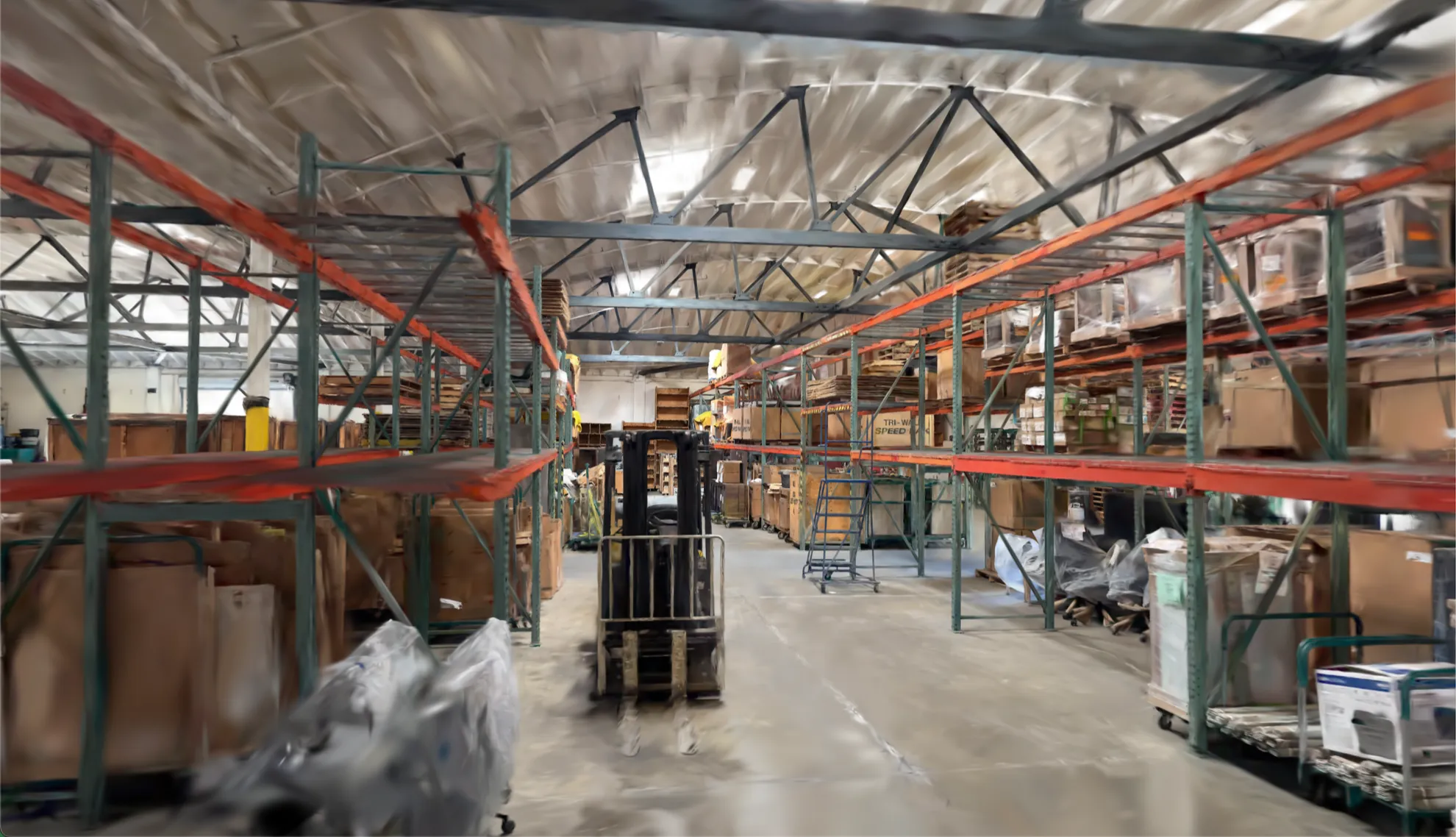 Reconstructed warehouse aisle with a forklift and pallet racking in Claryo's World Model